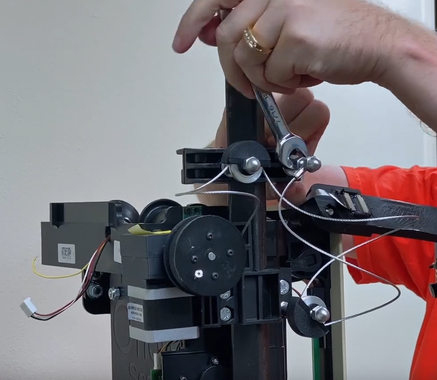 Attach the top mount by tightening the front bolt on the mount